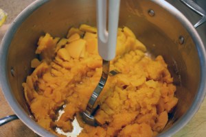 Mashing butternut squash with hand masher. ©2014 Deborah Kaplan