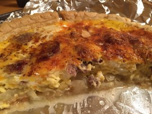 Bratwurst and onion quiche half consumed.