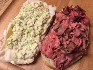 Sweet & Hot mustard, Swiss cheese, coleslaw, roast beef on seedless rye ready to be put together.